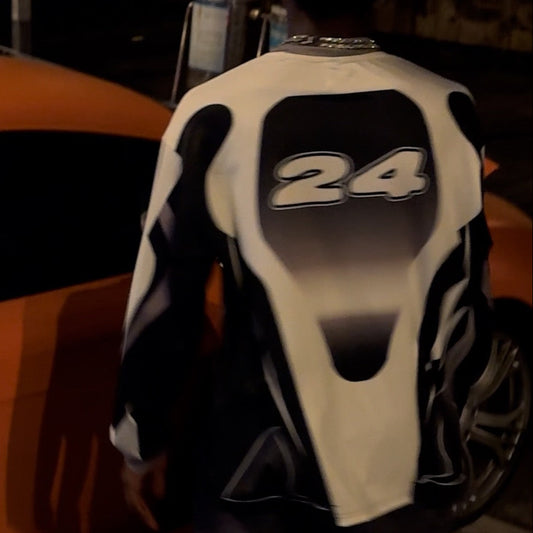 Close-up of a motorcycle seat with number 24 on an orange vehicle background